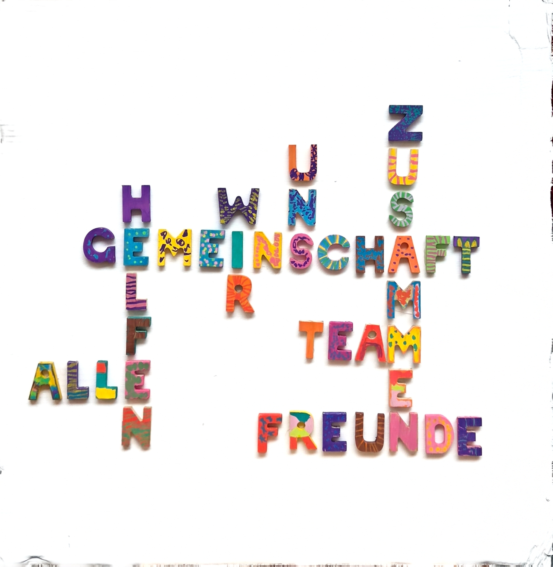 Kreuzworträtsel aus Holzbuchstaben zum Thema Gemeinschaft
