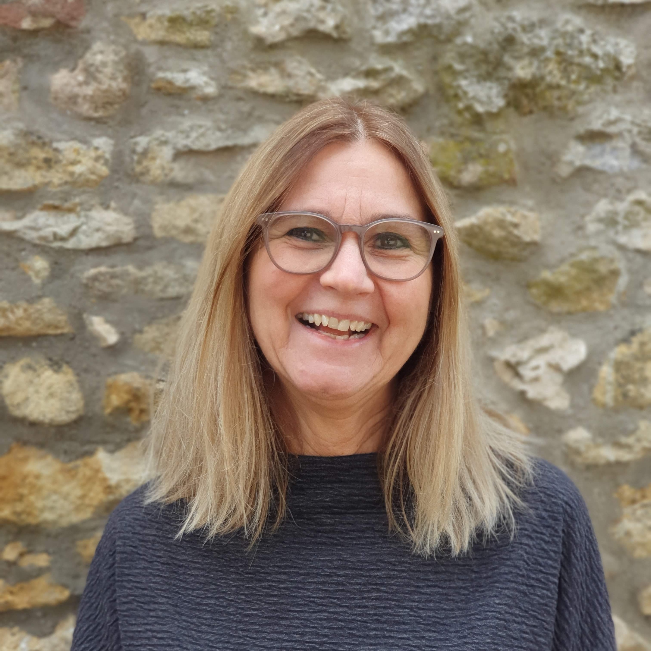 Eine Frau mit schulterlangen, braun/blonden Haaren