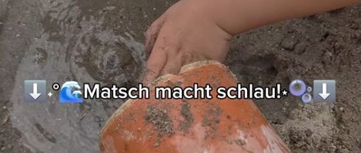 Kinder spielen mit Wasser im Sand